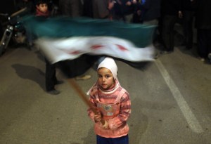 A girl waves a Syrian opposition flag during a protest against President Bashar al-Assad, February 27, 2012. (Goran Tomasevic/Courtesy Reuters)